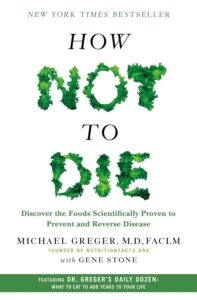 Cover of 'How Not to Die' by Michael Greger, M.D. with green and black text, one of the 10 Essential Books on Veganism and Plant-Based Living