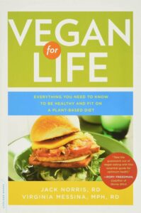 Cover of 'Vegan for Life' by Jack Norris and Virginia Messina with colorful fruits and vegetables, among 10 Essential Books on Veganism and Plant-Based Living